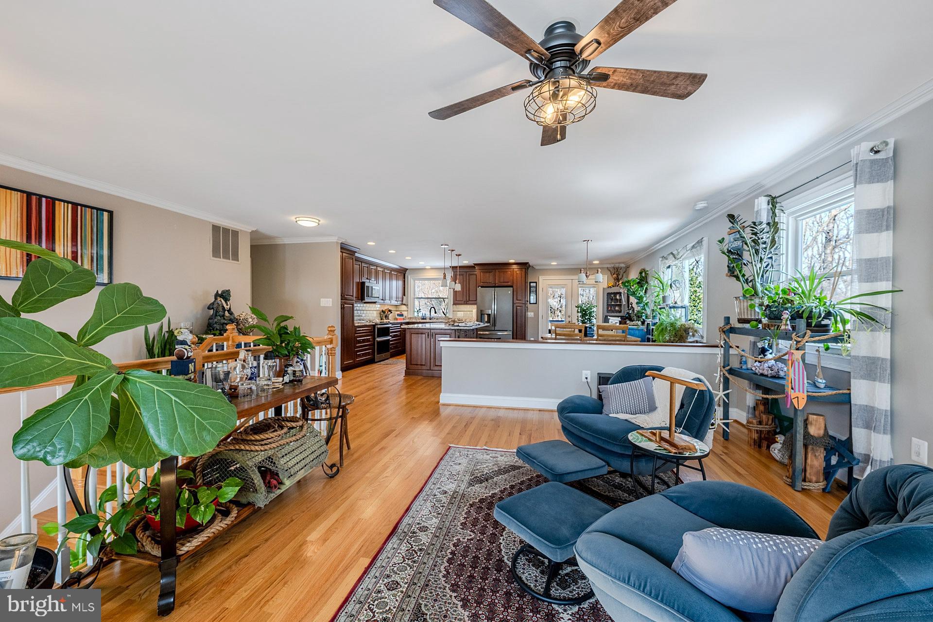 6112 Harmon Place Springfield, VA 22152 - Photo 14 of 33 a living room with furniture gym equipment and a chandelier