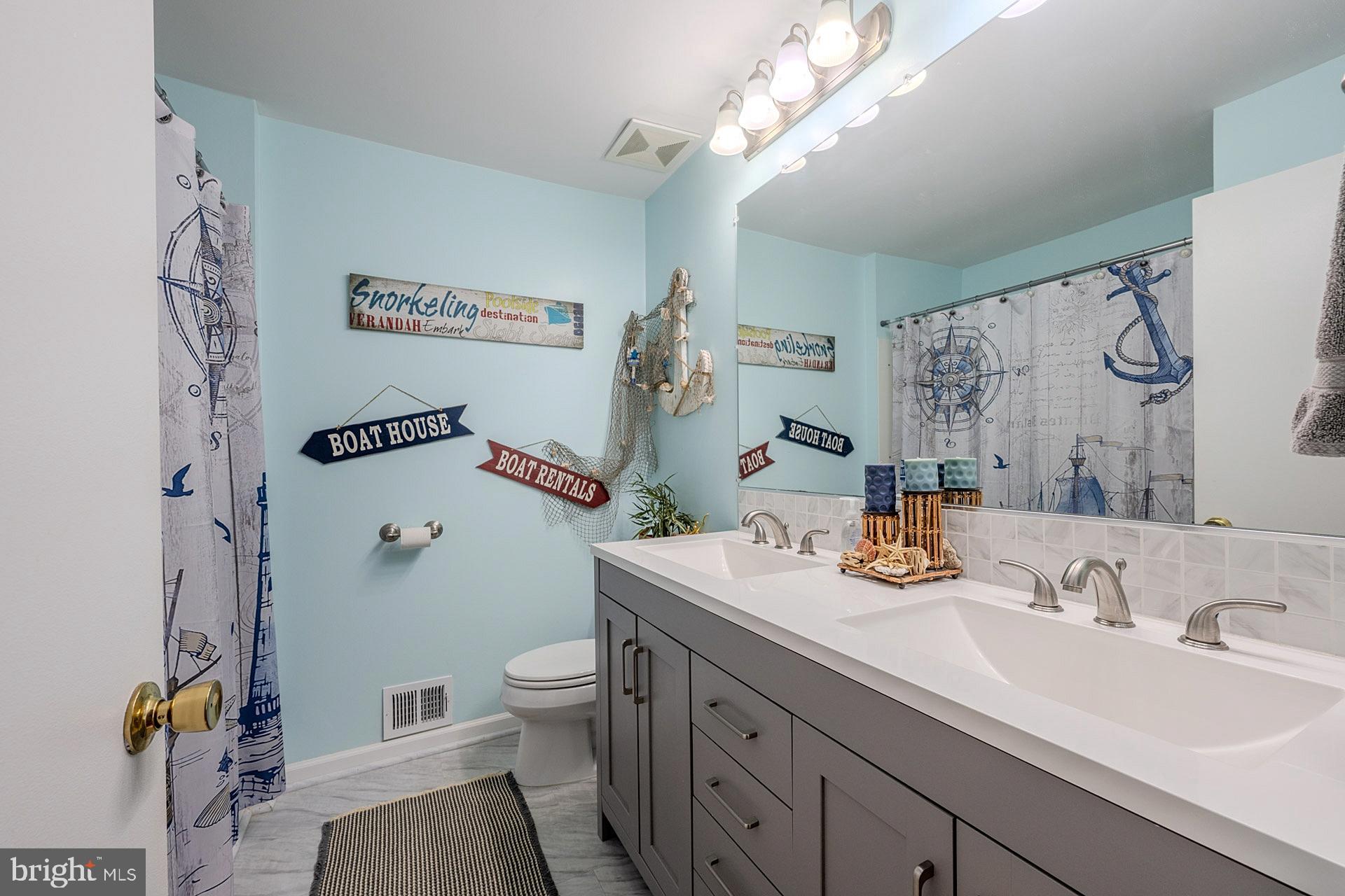 6112 Harmon Place Springfield, VA 22152 - Photo 21 of 33 a bathroom with a sink a toilet and a mirror