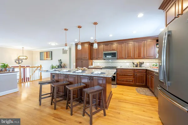 a kitchen with a table chairs stove and cabinets