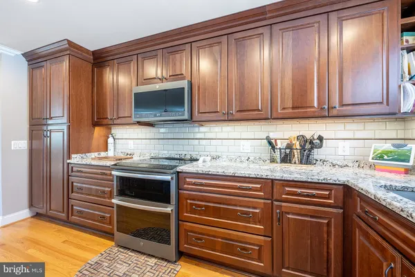 a kitchen with granite countertop stainless steel appliances and cabinets