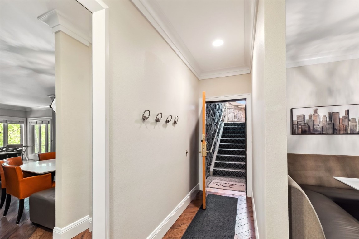 1207 West Keystone Road, Unit 2701 Keystone, CO 80435 - Photo 29 of 41 Corridor with ornamental molding, wood finished floors, and stairway