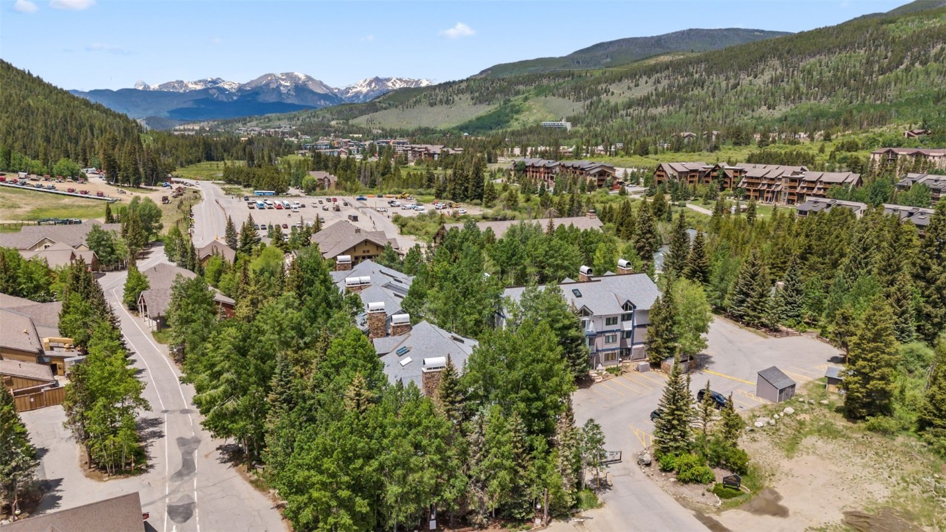 1207 West Keystone Road, Unit 2701 Keystone, CO 80435 - Photo 38 of 41 Aerial view of residential area featuring mountains and a heavily wooded area