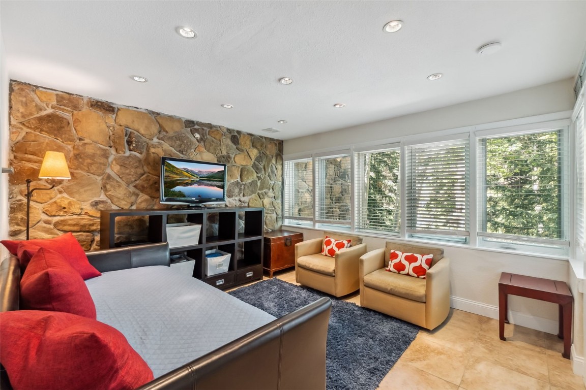 Living room with recessed lighting and light tile patterned floors