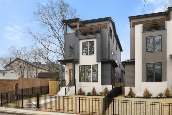 a view of a house with a small yard and furniture