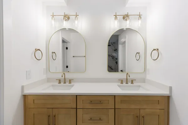 a bathroom with a double vanity sink and a mirror