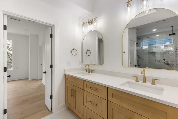 a bathroom with double vanity sinks and a mirror