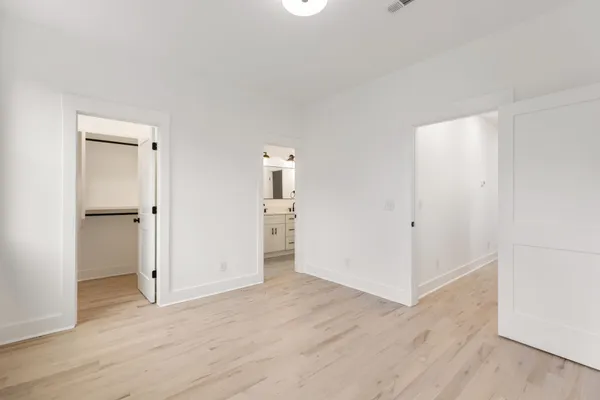 an empty room with wooden floor and closet