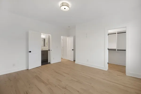 a view of a big room with closet and wooden floor