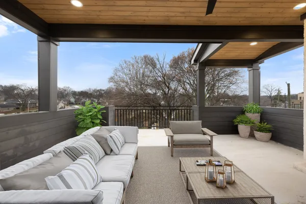 a balcony with furniture and a potted plant