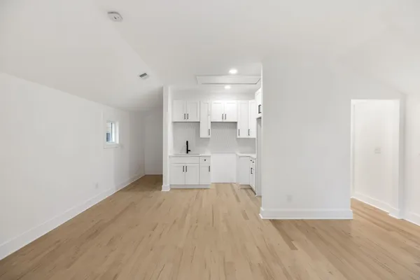 a view of a kitchen with wooden floor