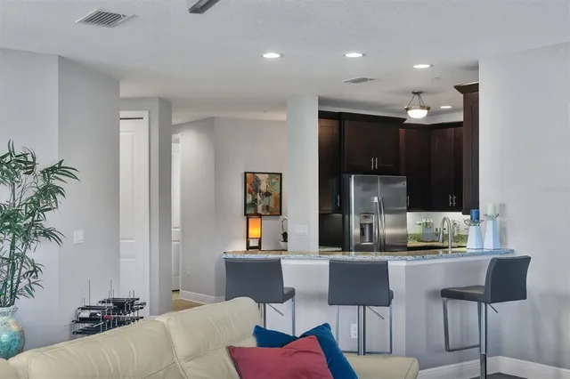 a kitchen with a stove a refrigerator and a dining table