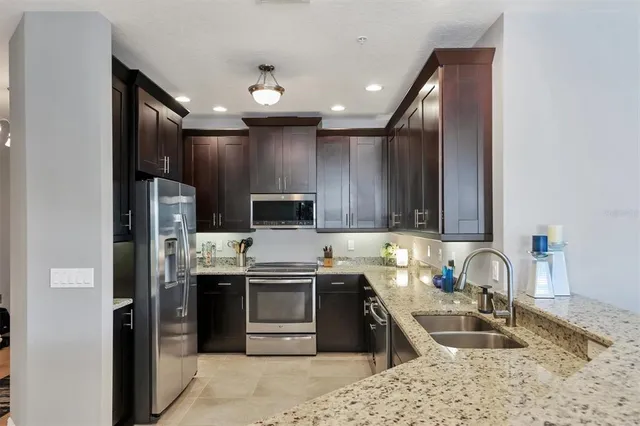 a kitchen with a sink stove and microwave