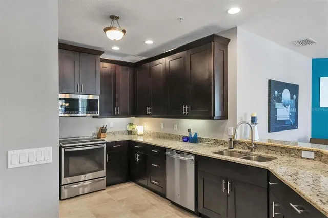a kitchen with granite countertop a sink and a counter top space