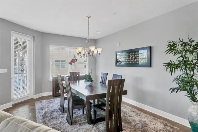 a view of a dining room with furniture and chandelier