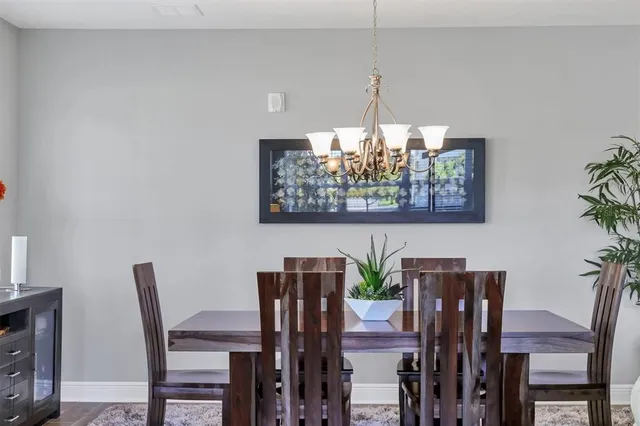 a view of a dining room with furniture and chandelier