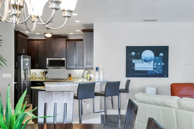 a bedroom with a bed a table window and couch