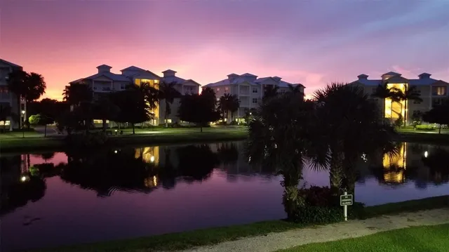 a view of a yard in front of the house with swimming pool and outdoor seating