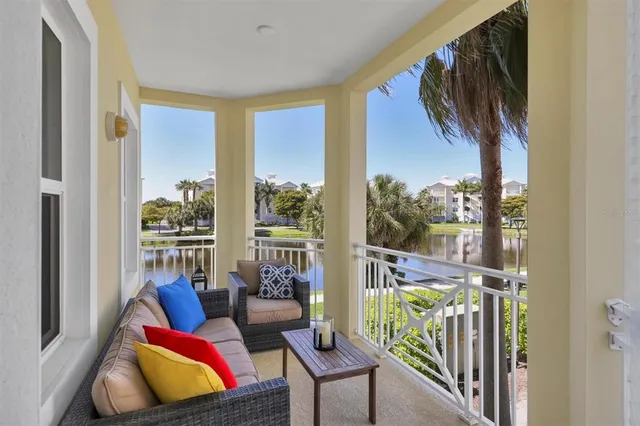 a view of a chair and tables in the patio in front of a house
