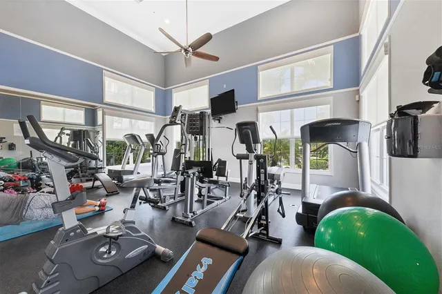 a view of pool with lawn chairs and wooden fence
