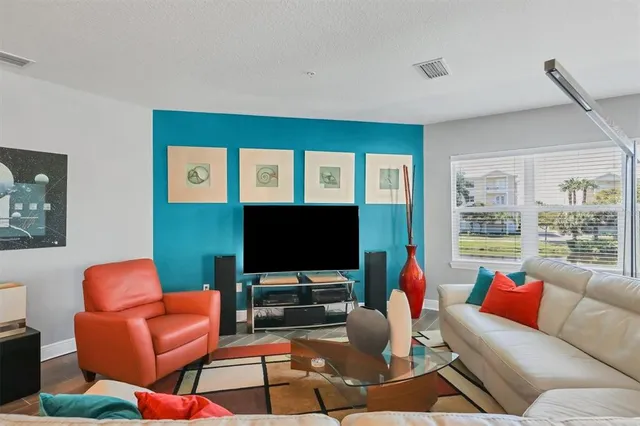 a living room with furniture and a flat screen tv