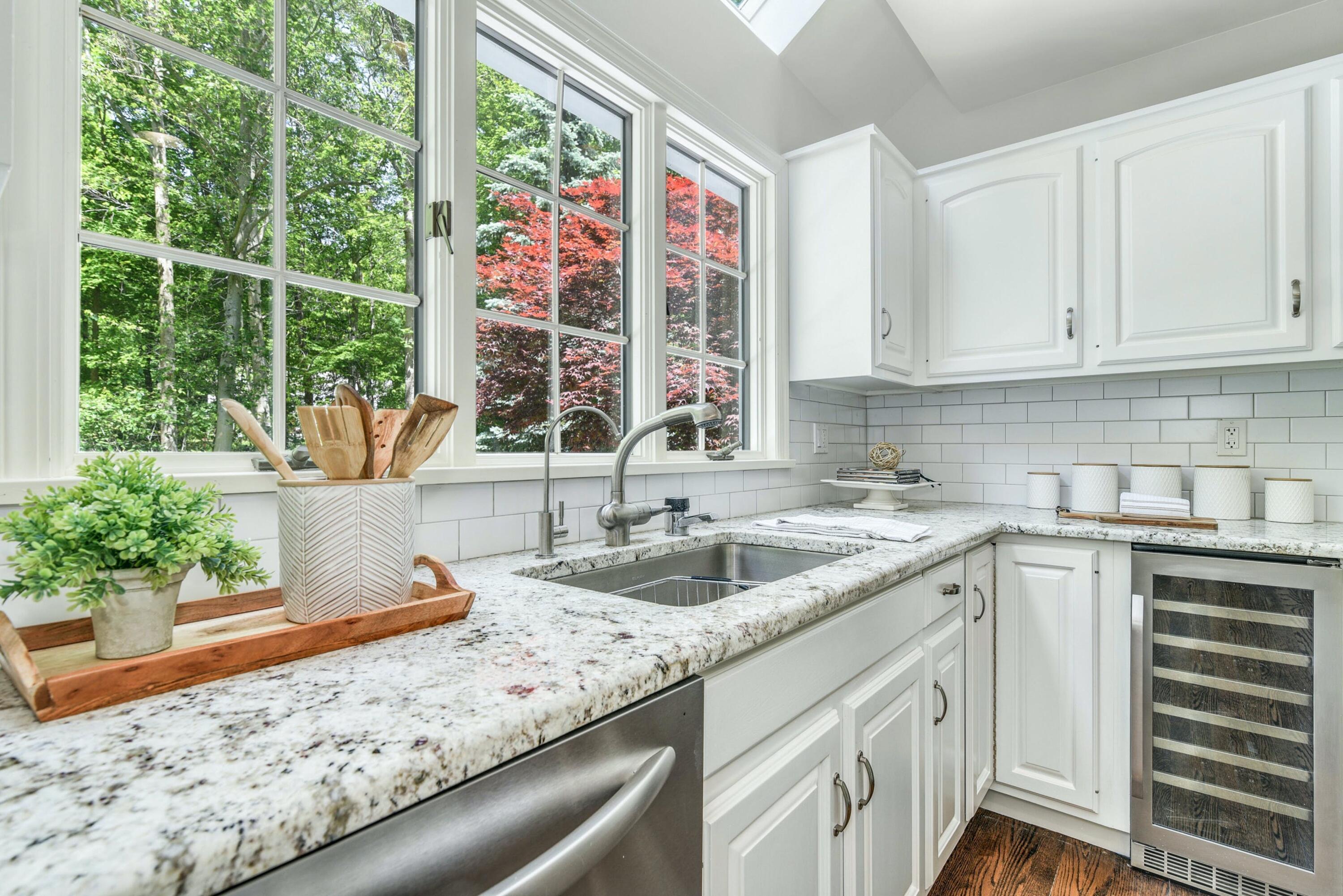 220 Old Norwalk Road New Canaan, CT 06840 - Photo 22 of 36 a kitchen with granite countertop a sink and a window