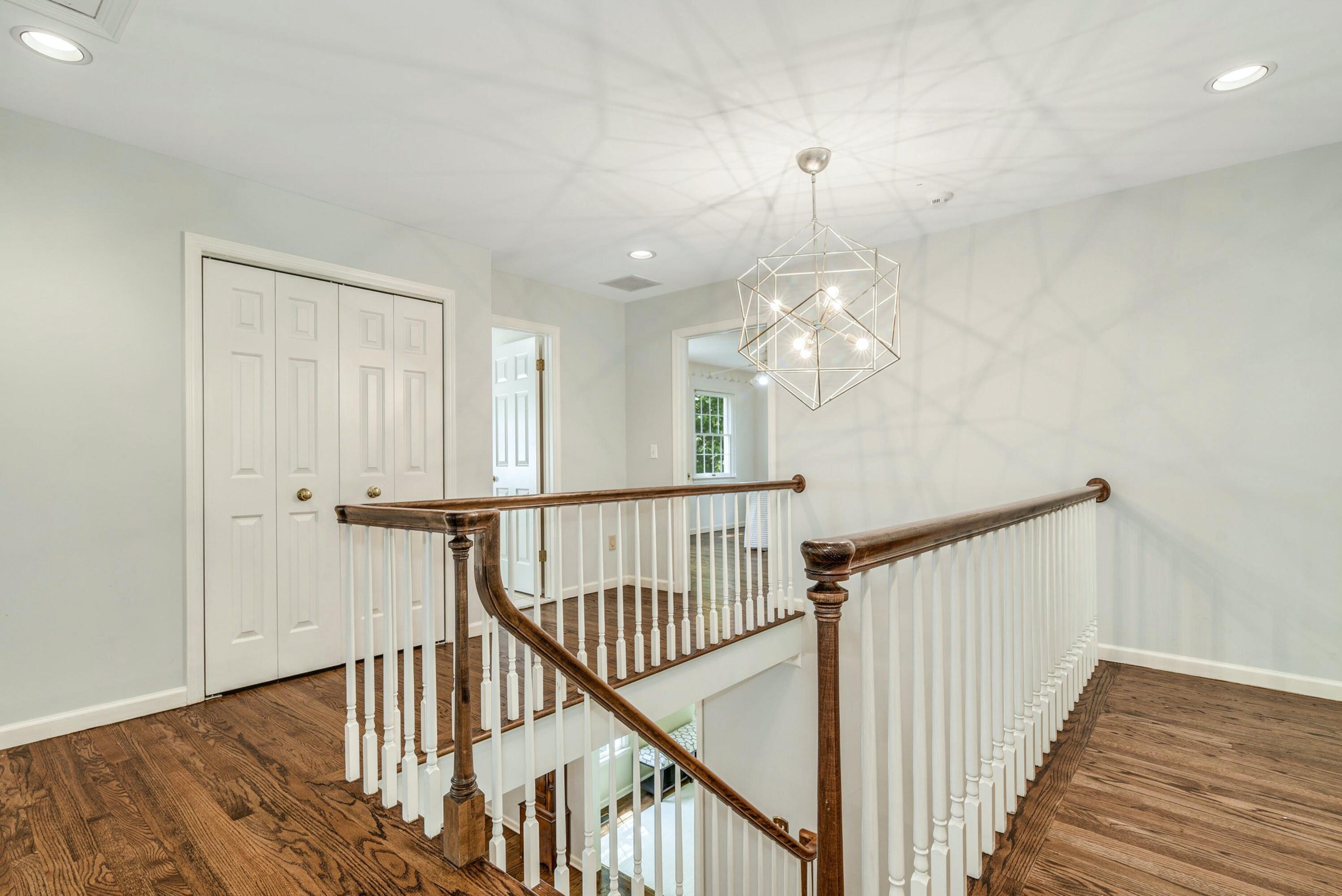 220 Old Norwalk Road New Canaan, CT 06840 - Photo 24 of 36 a view of a hallway with wooden floor and staircase