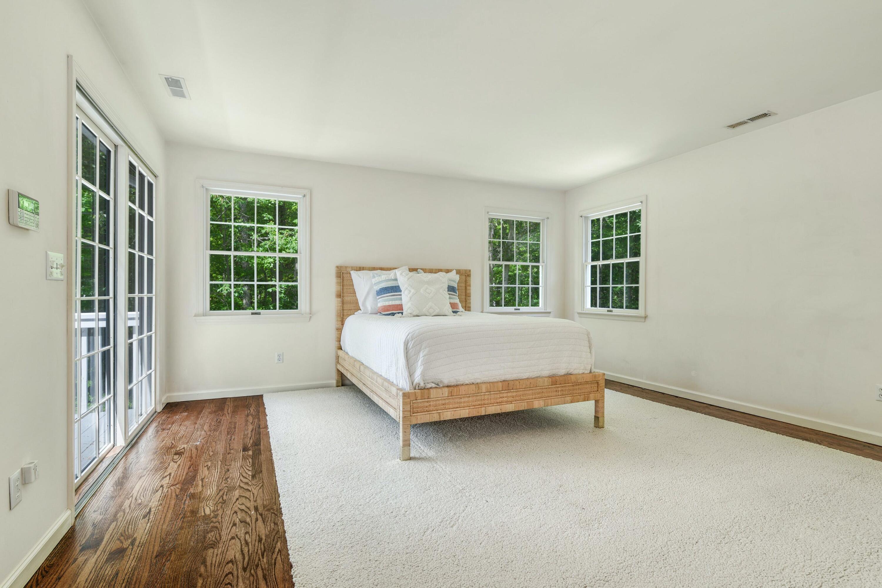 220 Old Norwalk Road New Canaan, CT 06840 - Photo 25 of 36 a bedroom with a bed and windows