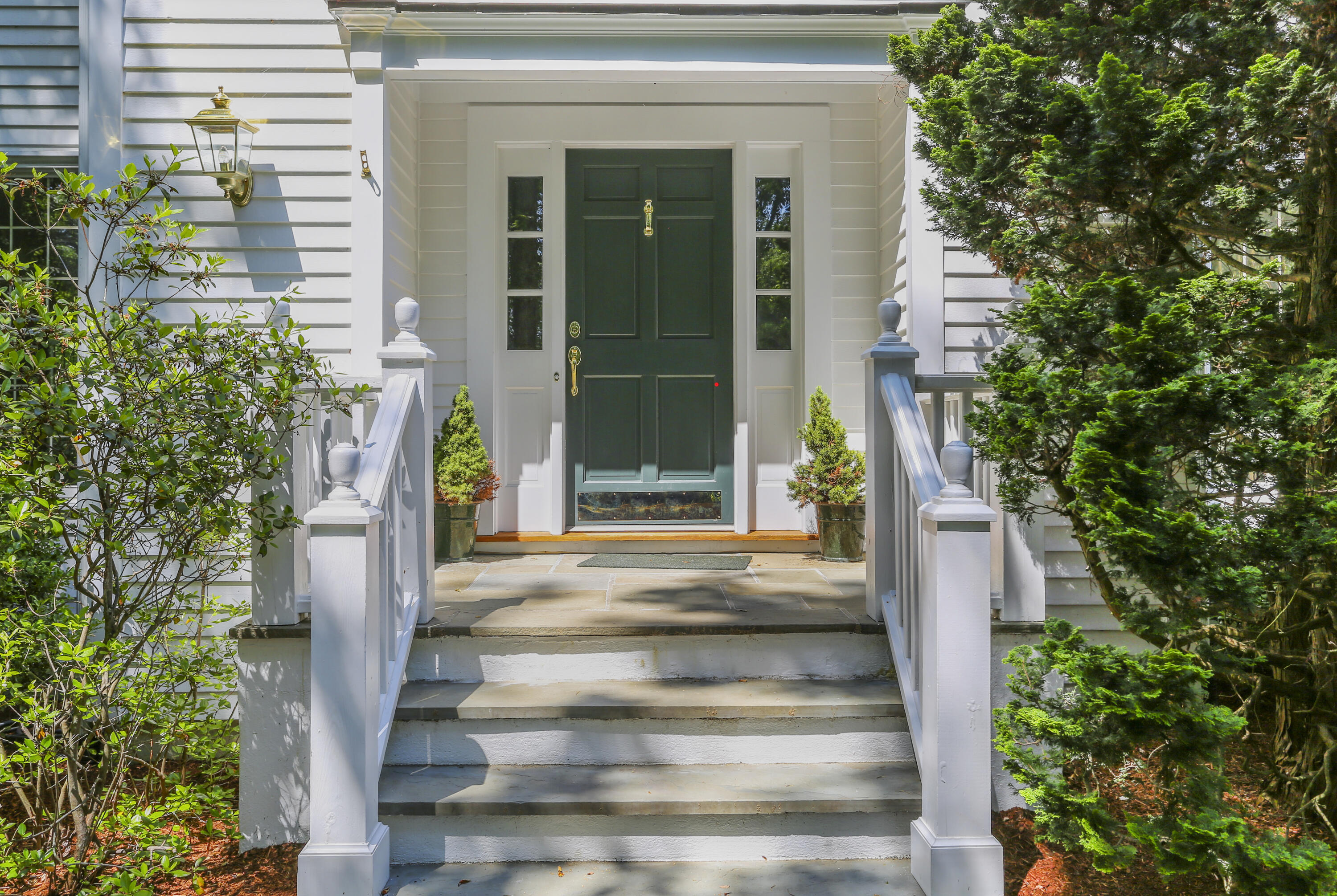 220 Old Norwalk Road New Canaan, CT 06840 - Photo 3 of 36 a front view of a house with a garden