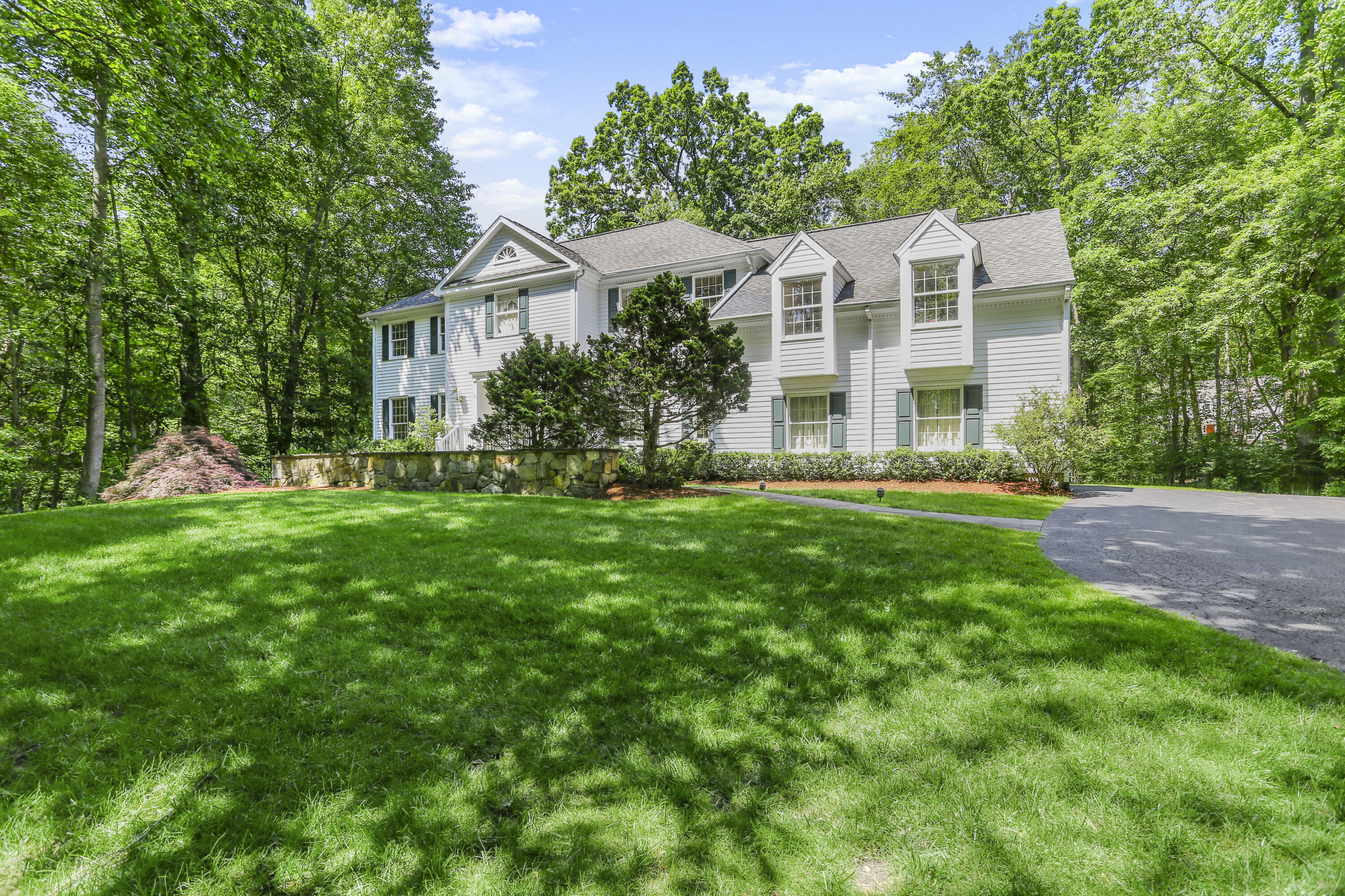 220 Old Norwalk Road New Canaan, CT 06840 - Photo 4 of 36 a front view of a house with garden and trees