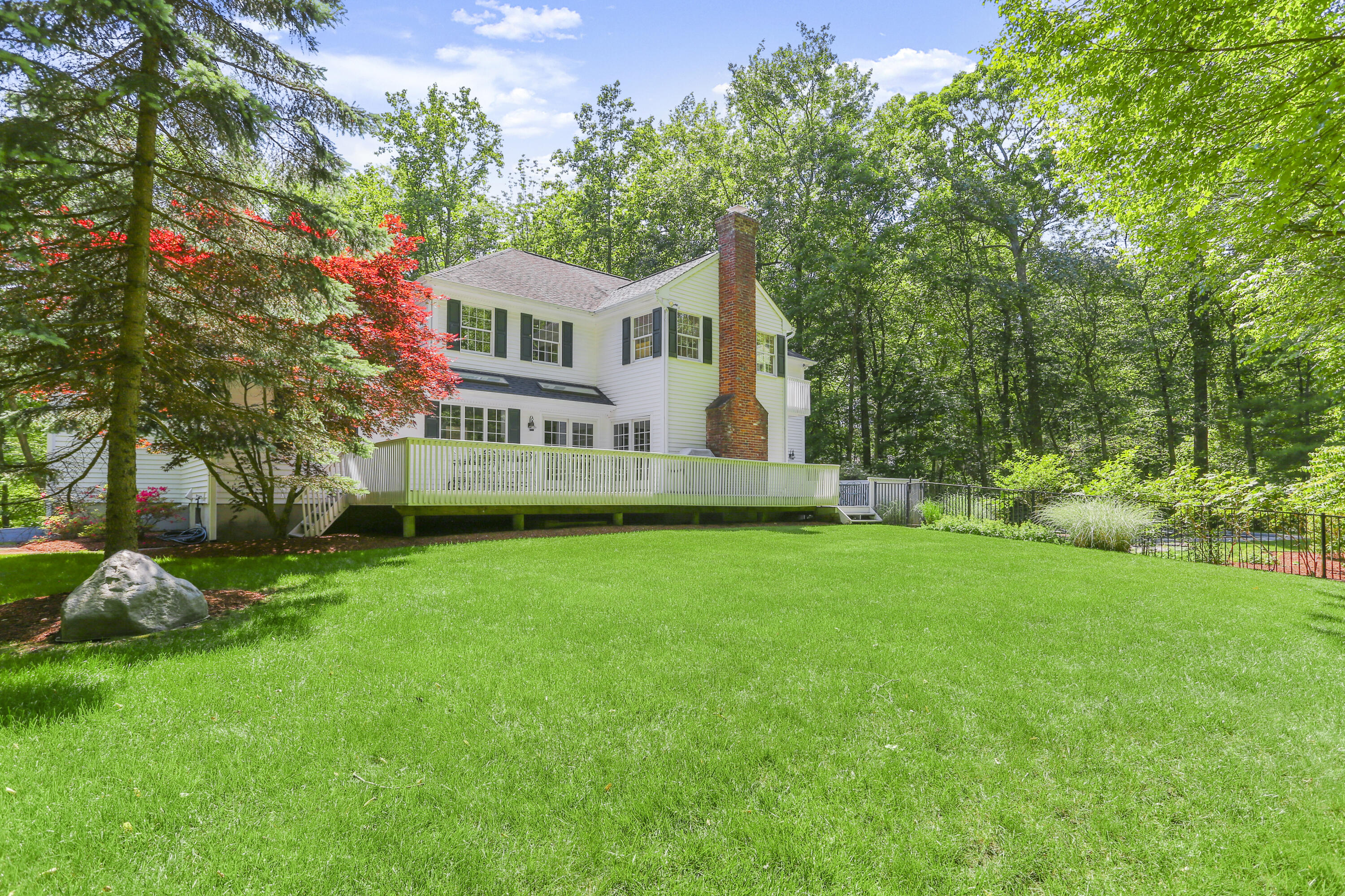 220 Old Norwalk Road New Canaan, CT 06840 - Photo 6 of 36 a front view of a house with a garden