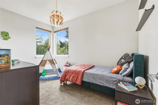 a bedroom with a bed and a chandelier