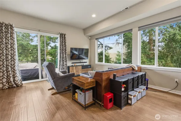 a dining room with furniture and wooden floor