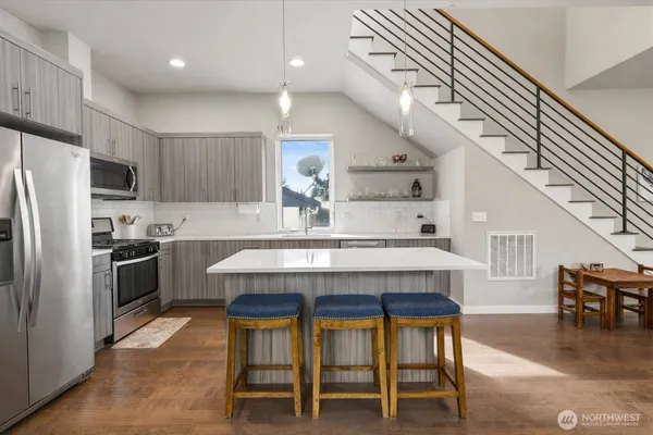 a kitchen with a sink a stove top oven and refrigerator