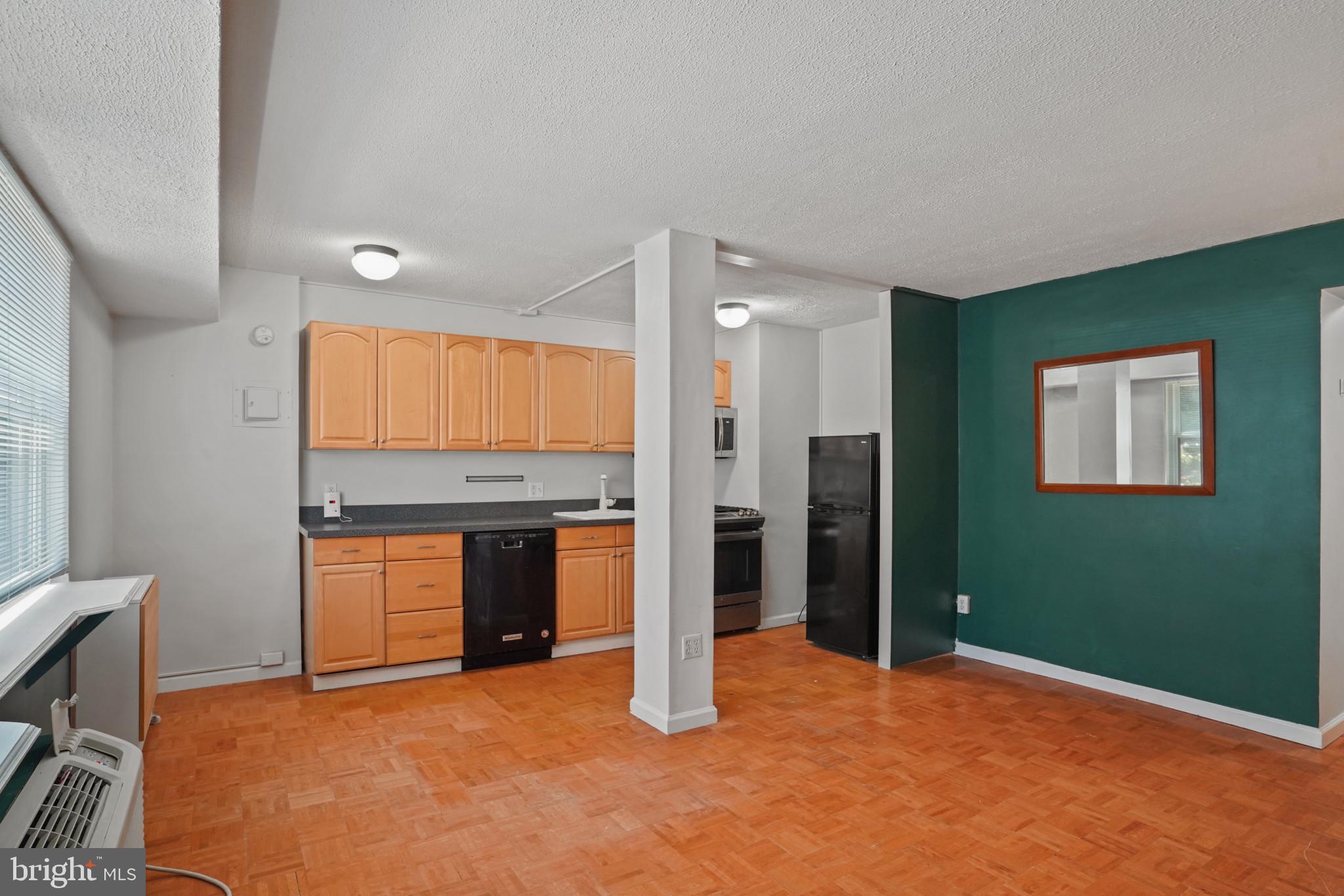 1801 Clydesdale Place Northwest, Unit 420 Washington, DC 20009 - Photo 11 of 33 a view of an empty room with a kitchen
