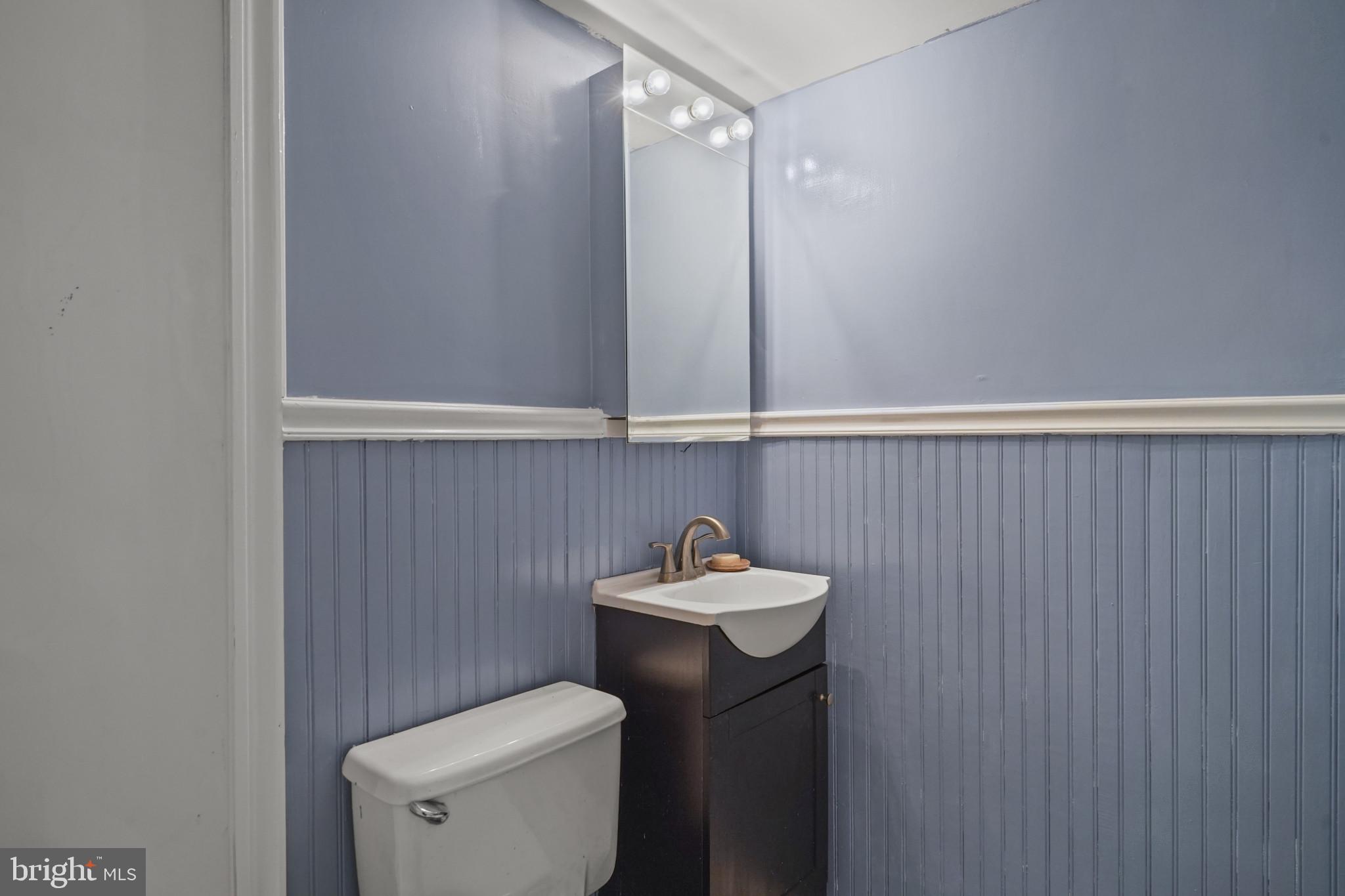 1801 Clydesdale Place Northwest, Unit 420 Washington, DC 20009 - Photo 19 of 33 a bathroom with a sink a toilet and a mirror