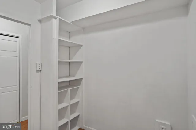 a view of a roof deck with couches and wooden floor