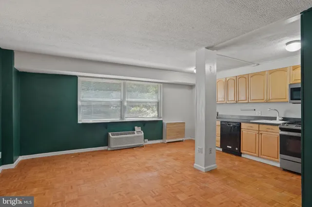 a kitchen with stainless steel appliances granite countertop a stove microwave and sink