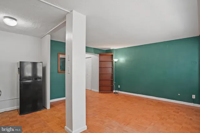 a view of an empty room with a kitchen