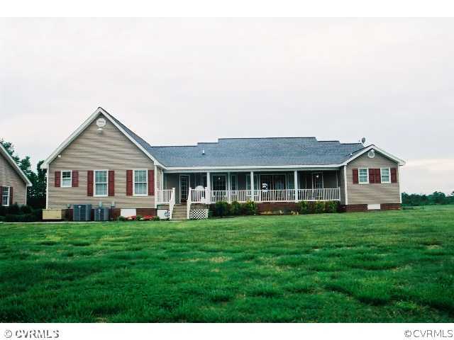 16775 Hudgins Road Dewitt, VA 23840 - Photo 2 of 11 a front view of a house with a yard and trees