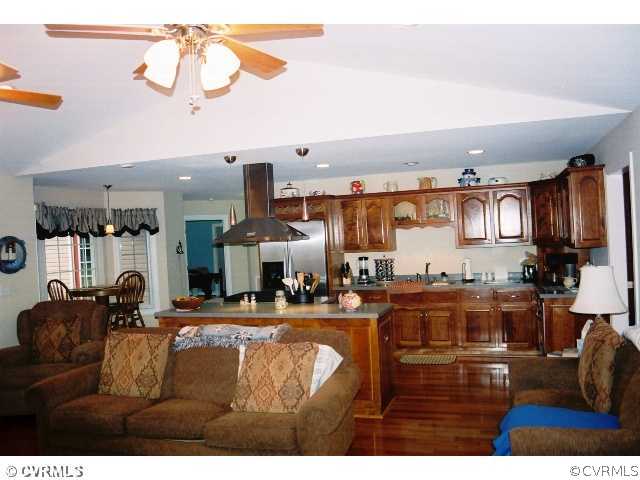 16775 Hudgins Road Dewitt, VA 23840 - Photo 6 of 11 a living room with lots of furniture and a kitchen view