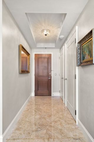 a view of a hallway with wooden floor and closet