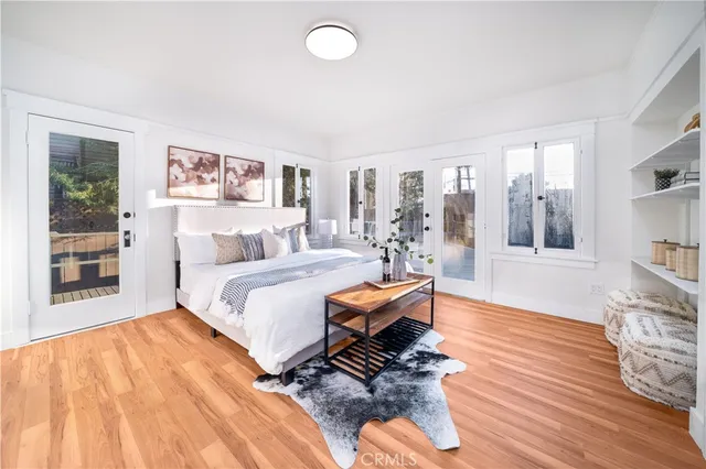 a bedroom with a bed and wooden floor
