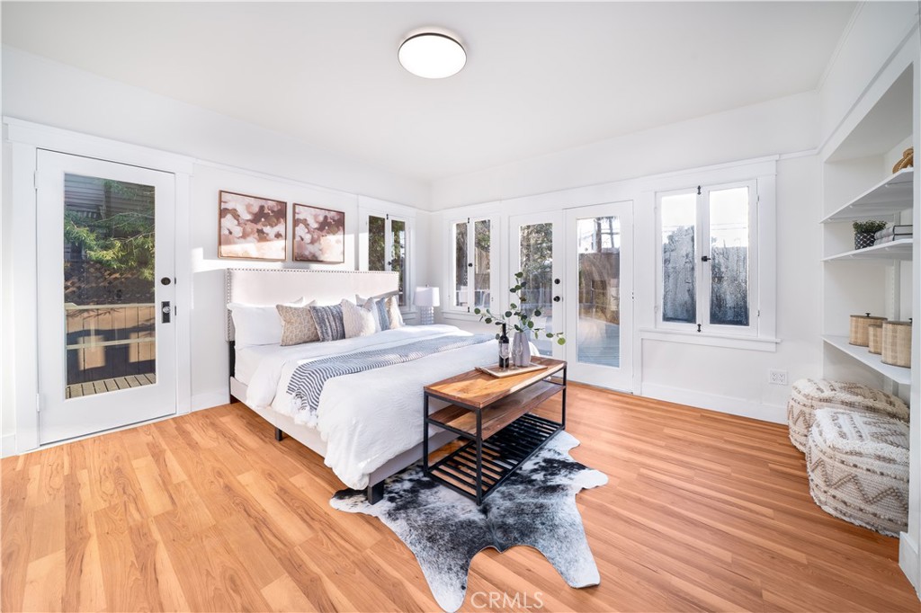 843 Cedar Avenue Long Beach, CA 90813 - Photo 14 of 42 a bedroom with a bed and wooden floor