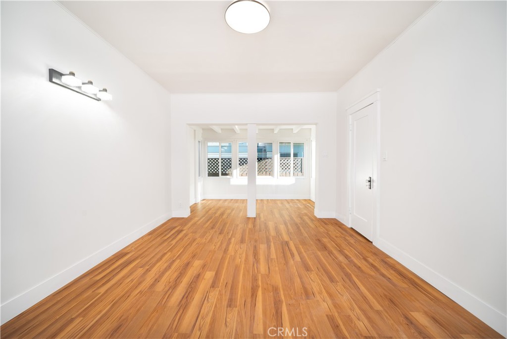 843 Cedar Avenue Long Beach, CA 90813 - Photo 15 of 42 an empty room with wooden floor and windows