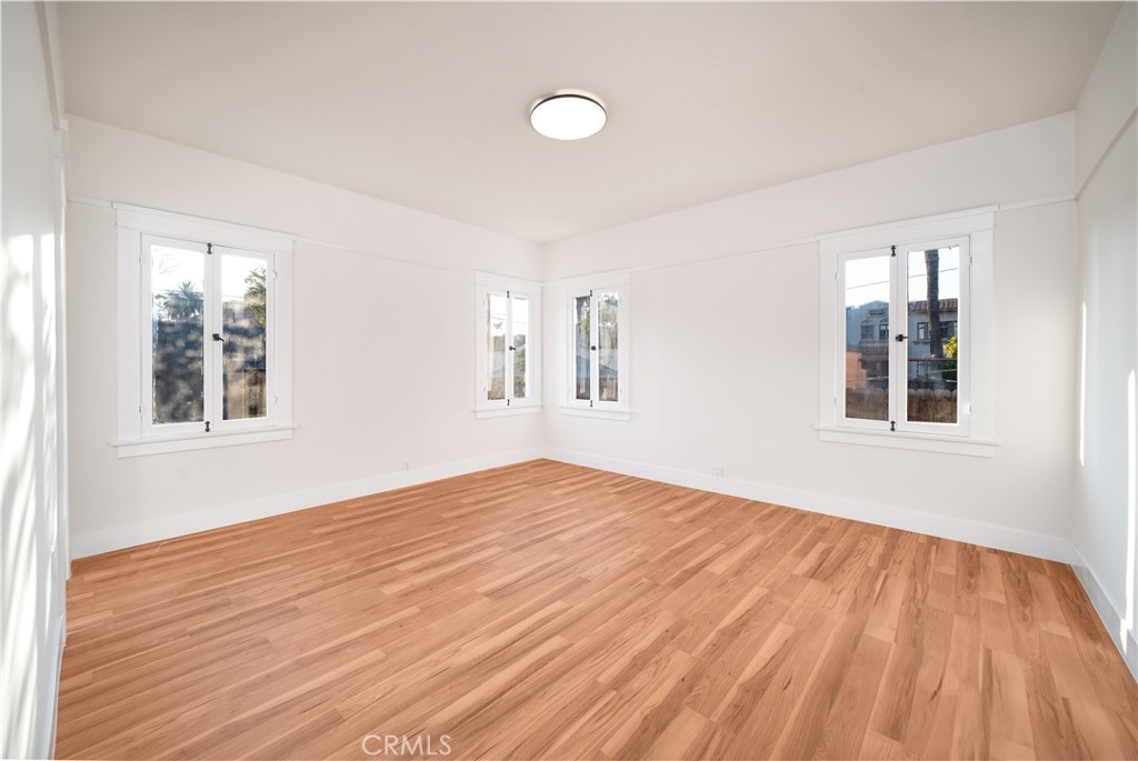 843 Cedar Avenue Long Beach, CA 90813 - Photo 18 of 42 a view of an empty room with wooden floor and a window