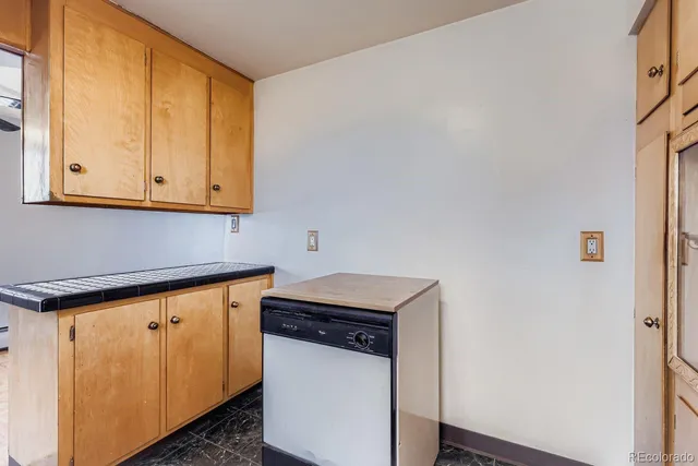 a utility room with wooden floor washer and dryer