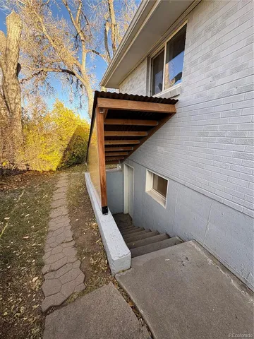 a white house that has a tree in front of it