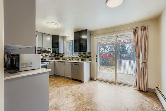 a kitchen that has a lot of cabinets and refrigerator