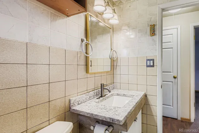 a bathroom with a sink shower and a mirror