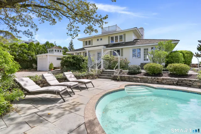a view of a house with backyard porch and sitting area